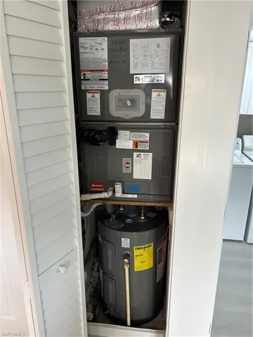 Utilities featuring washer / clothes dryer, heating unit, and water heater