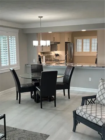 Dining area featuring crown molding and a notable chandelier