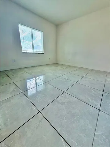 Tile flooring, neutral wall tones, and natural light from a window