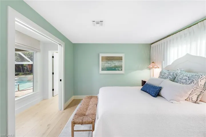 Spacious secondary bedroom with outdoor pool view