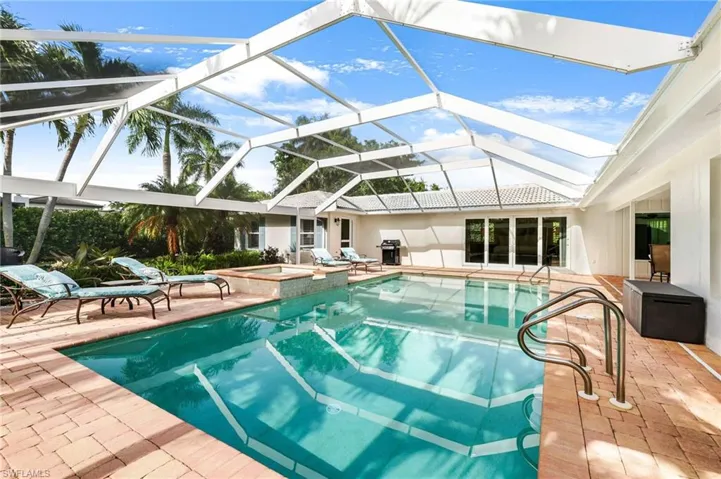 View of pool featuring an in ground hot tub, a lanai, and a patio area