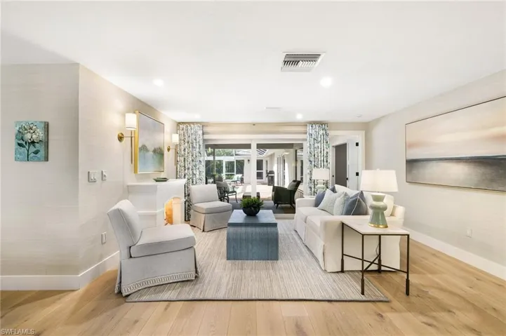 Living room overlooking outdoor living and pool area