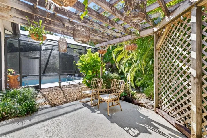 View of patio featuring glass enclosure and a sunroom