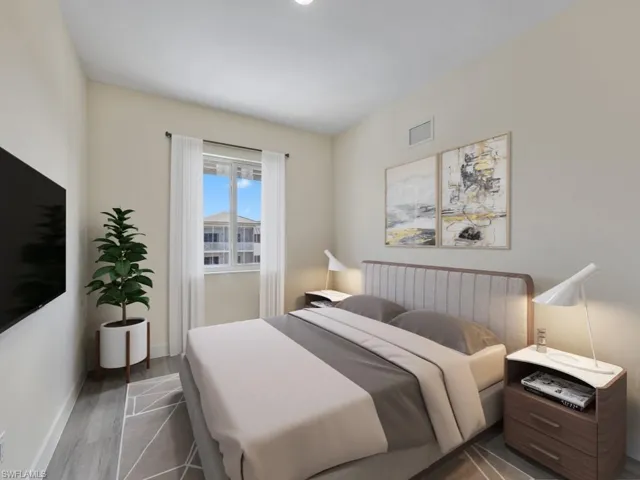 Virtually staged photo. Bedroom featuring vinyl flooring.