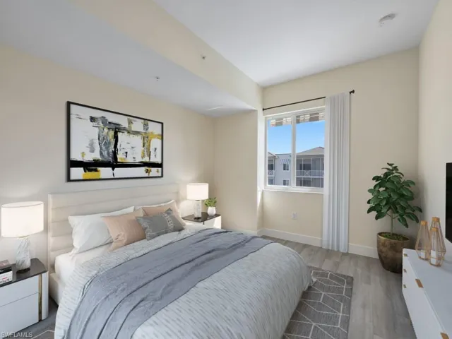 Virtually staged photo. Bedroom featuring vinyl flooring, a large window, and light-toned walls