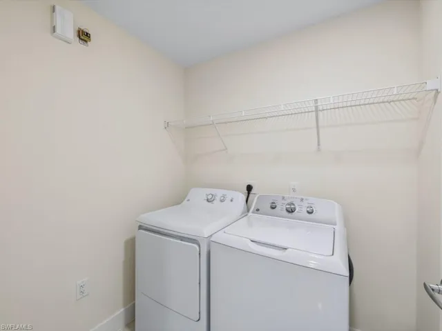 Dedicated laundry space featuring a white wire shelving unit