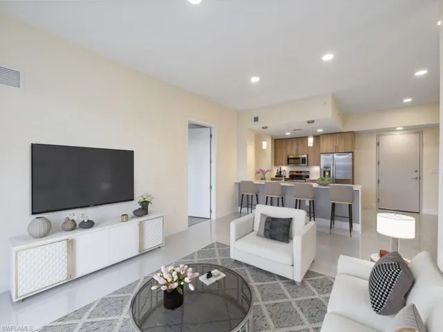 Virtually staged photo. Open-concept living area featuring polished tile flooring.