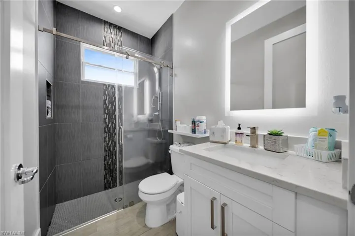 Bathroom with vanity and a stall shower