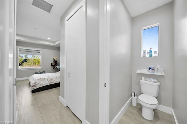 Ensuite bathroom featuring light wood-style flooring and recessed lighting