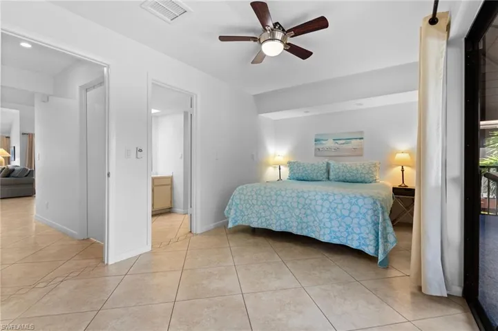 Bedroom with light tile patterned flooring and ceiling fan