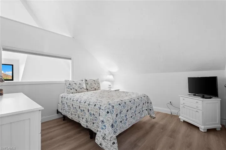 Bedroom featuring vaulted ceiling and light wood-type flooring
