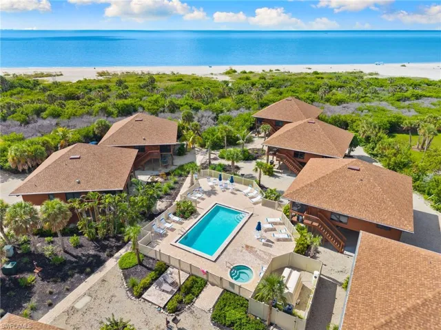 Drone / aerial view of a pool area and extended coastline