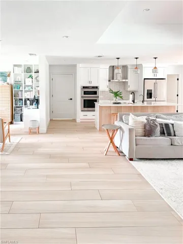Living room featuring sink and light hardwood / wood-style floors