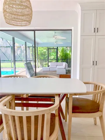 Dining area featuring a healthy amount of sunlight, an inviting chandelier, and hardwood / wood-style floors