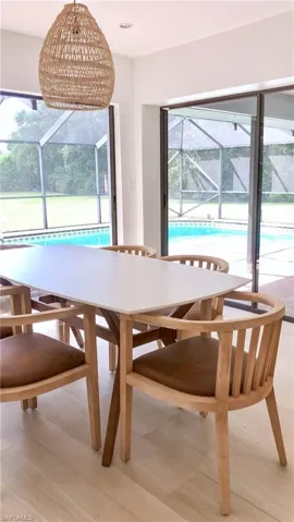 Unfurnished dining area with light hardwood / wood-style floors and a chandelier