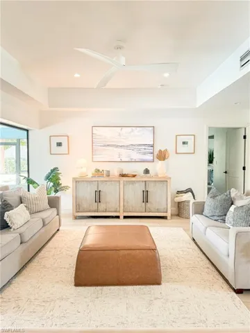 Living room featuring ceiling fan and wood-type flooring