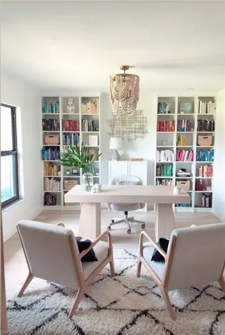 Office with an inviting chandelier and wood-type flooring