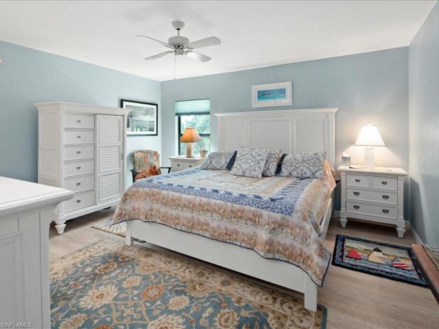 Primary bedroom is off the living room.  It, too, has new luxury vinyl flooring, new hurricane window (2022), walk in closet and en-suite bath.