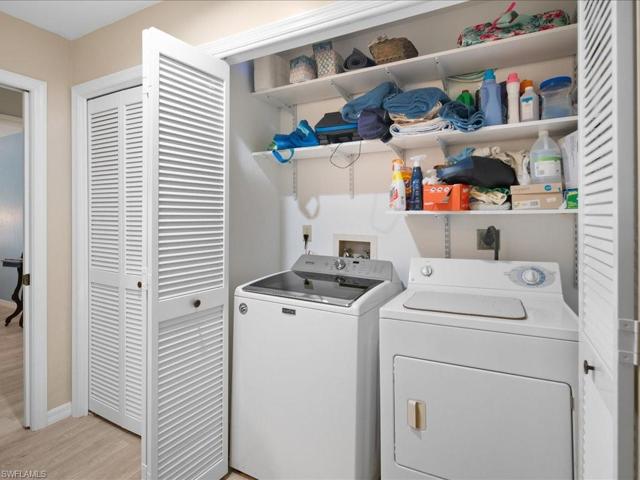 Full sized Maytag washer and GE dryer are in a closet outside the guest bath.  A full sized linen closet is to the left.