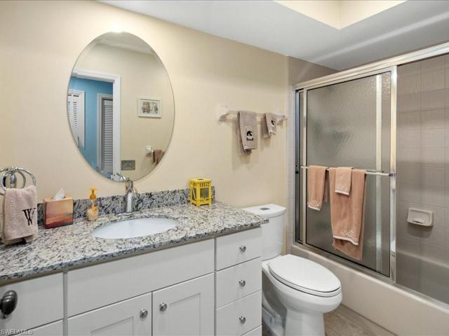 Guest bath renovated in 2020 has new cabinetry, granite top, single sink décor mirror and lighting, tub and shower and comfort level toilet.