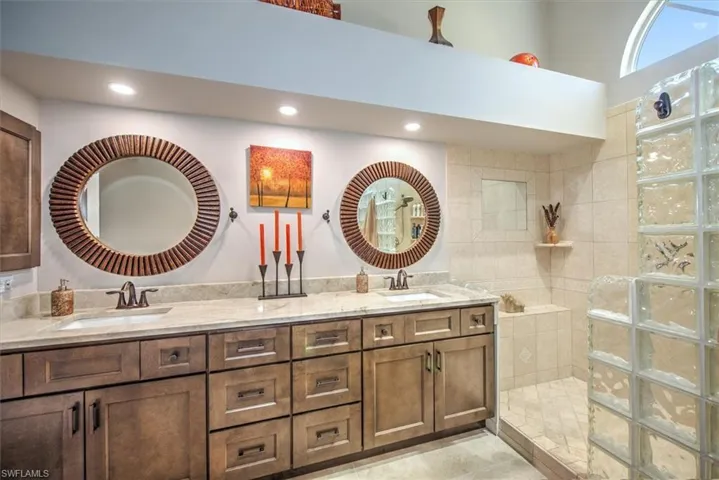 Full bathroom with recessed lighting, a walk in shower, and a sink