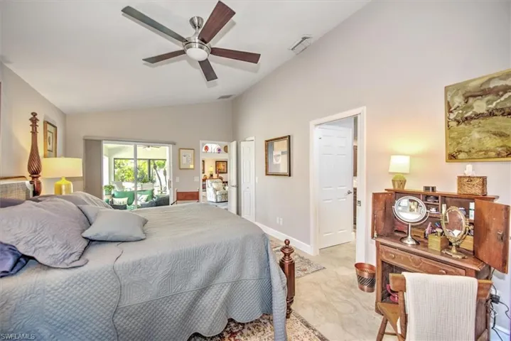 Bedroom with lofted ceiling, baseboards, visible vents, and ceiling fan