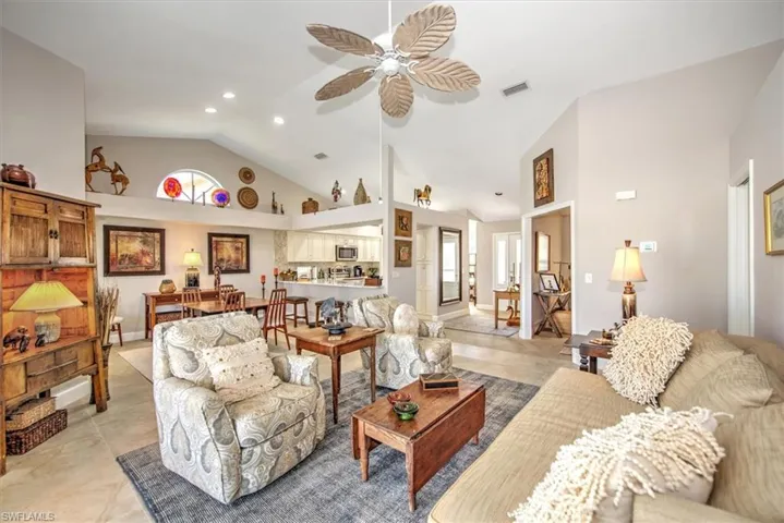 Living area with recessed lighting, a ceiling fan, visible vents, and high vaulted ceiling