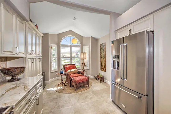 Living area featuring baseboards and vaulted ceiling