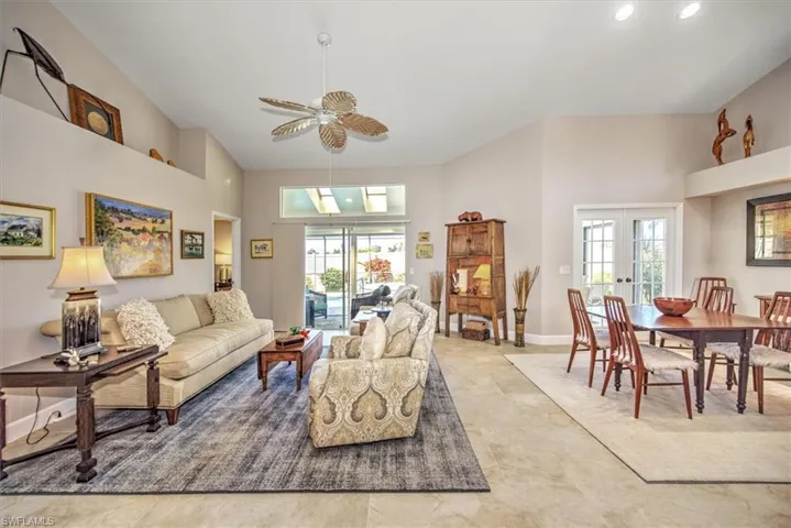 Living room featuring a towering ceiling, french doors, and a wealth of natural light