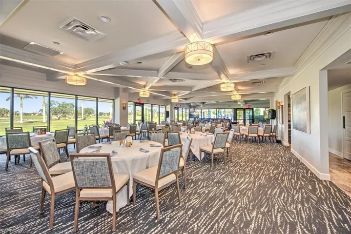 Carpeted dining room with beam ceiling, crown molding, visible vents, and coffered ceiling