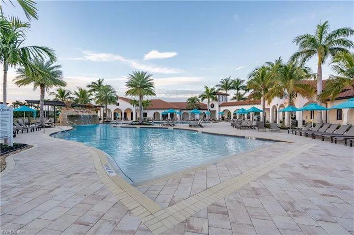 View of swimming pool featuring pool water feature and a patio area