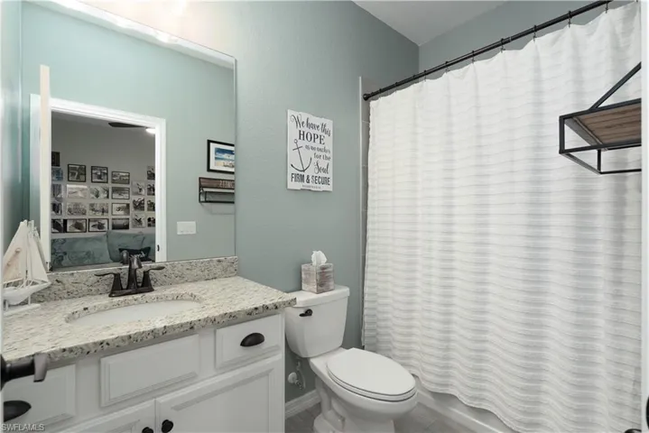 Bathroom with tile patterned floors, vanity, and toilet