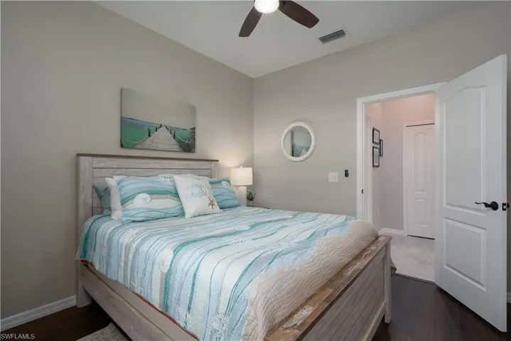 Bedroom featuring dark hardwood / wood-style floors and ceiling fan