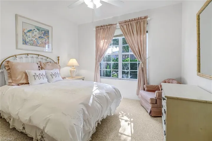 Carpeted bedroom with ceiling fan
