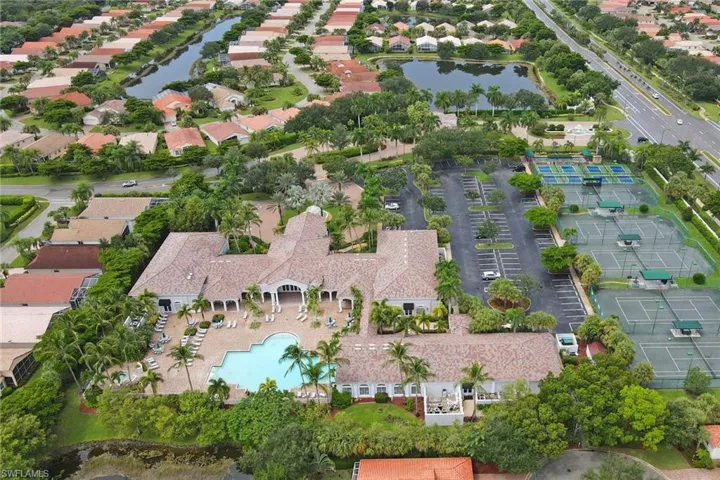 Birds eye view of property with a water view