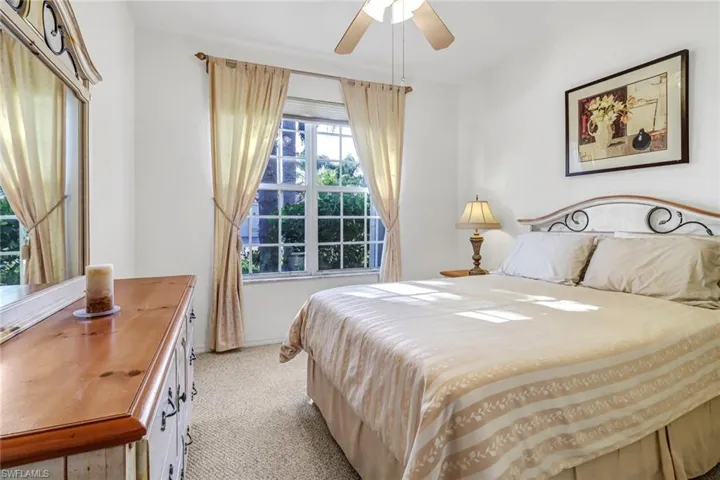 Carpeted bedroom with ceiling fan