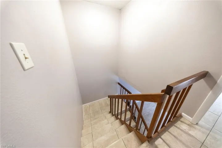 Staircase with tile patterned floors
