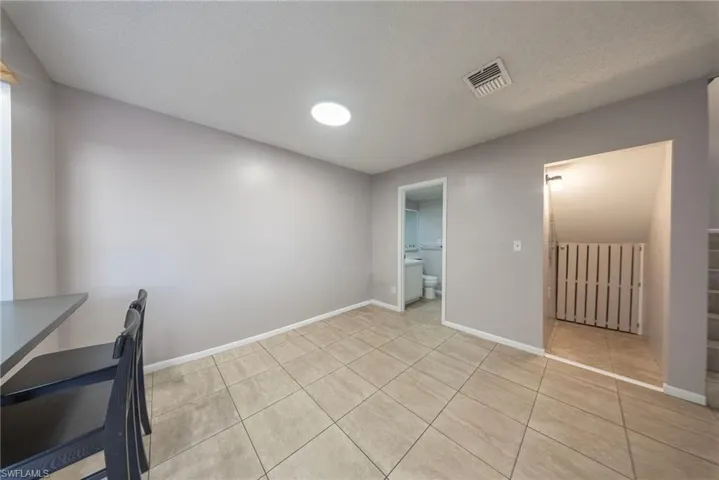 Unfurnished dining area with a textured ceiling and light tile patterned floors