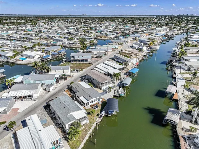 Aerial perspective of suburban area featuring a large body of water