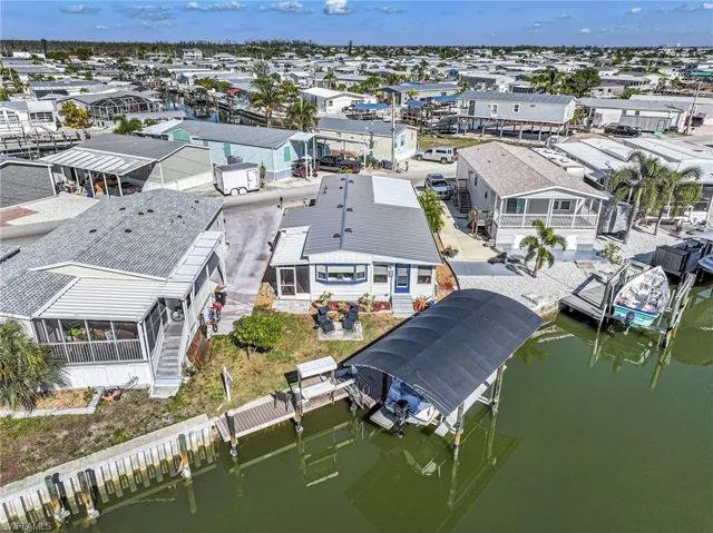 Aerial view of residential area featuring a nearby body of water