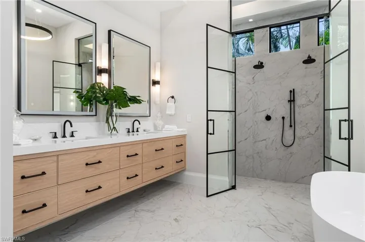Bathroom with vanity and a shower with door