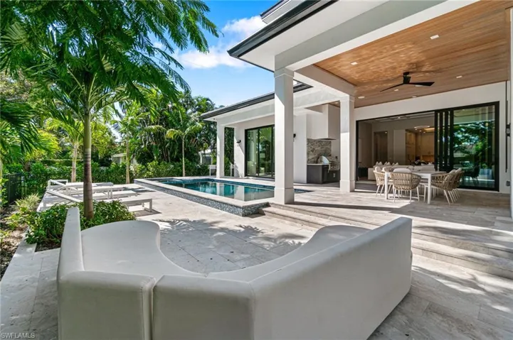 View of swimming pool with ceiling fan, an outdoor hangout area, and a patio area