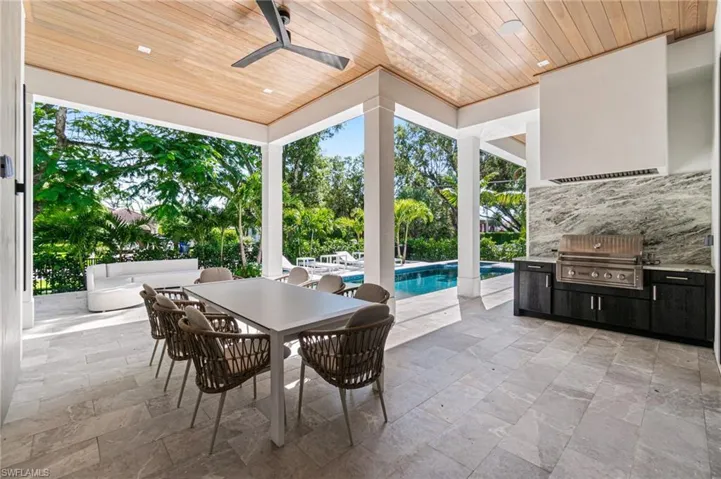 View of patio / terrace with grilling area, an outdoor kitchen, and ceiling fan