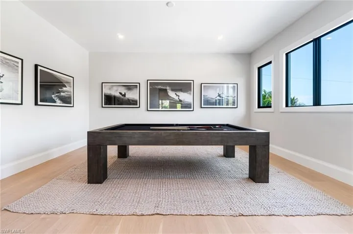 Rec room with pool table and hardwood / wood-style floors