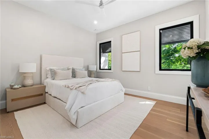 Bedroom with ceiling fan and wood-type flooring