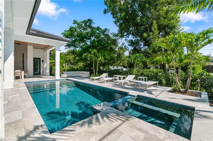 View of pool featuring outdoor lounge area, a patio, and an in ground hot tub