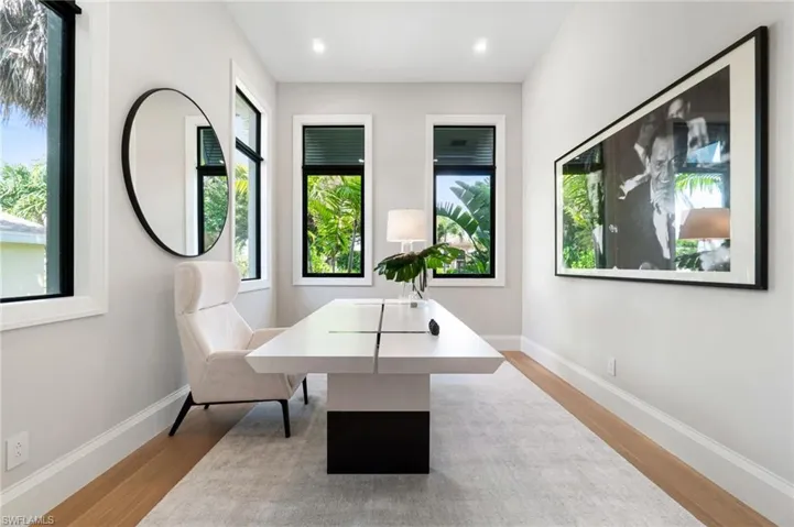 Office space featuring a healthy amount of sunlight and light hardwood / wood-style flooring