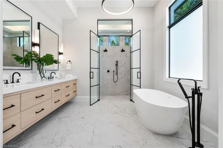Bathroom featuring vanity and plus walk in shower