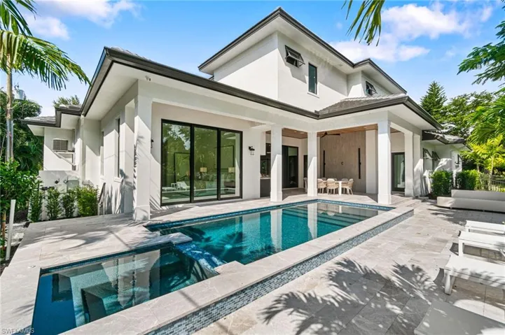 Back of house featuring ceiling fan and a patio area