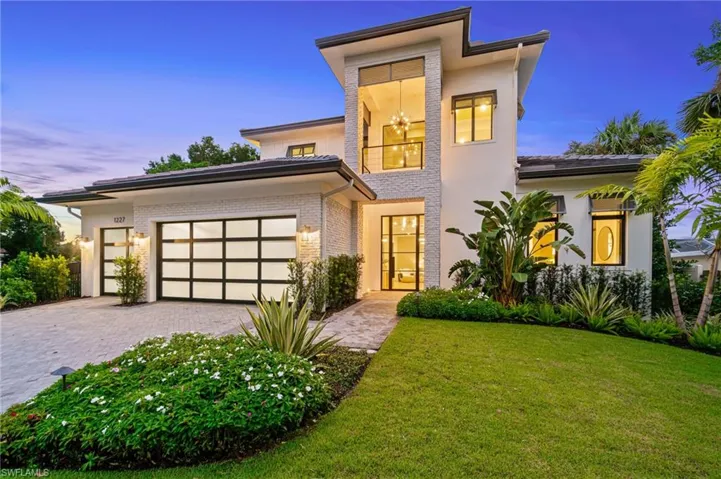 Contemporary house featuring a garage and a yard